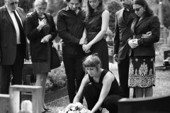 family-laying-flowers-grave